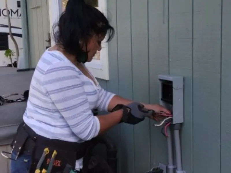 Licensed electrician wiring an exterior subpanel in Selma